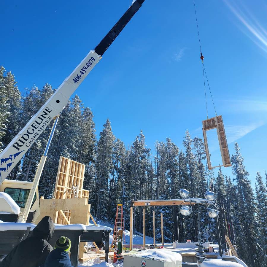 prebuilt wall panels are being assembled to build a new home construction in Montana